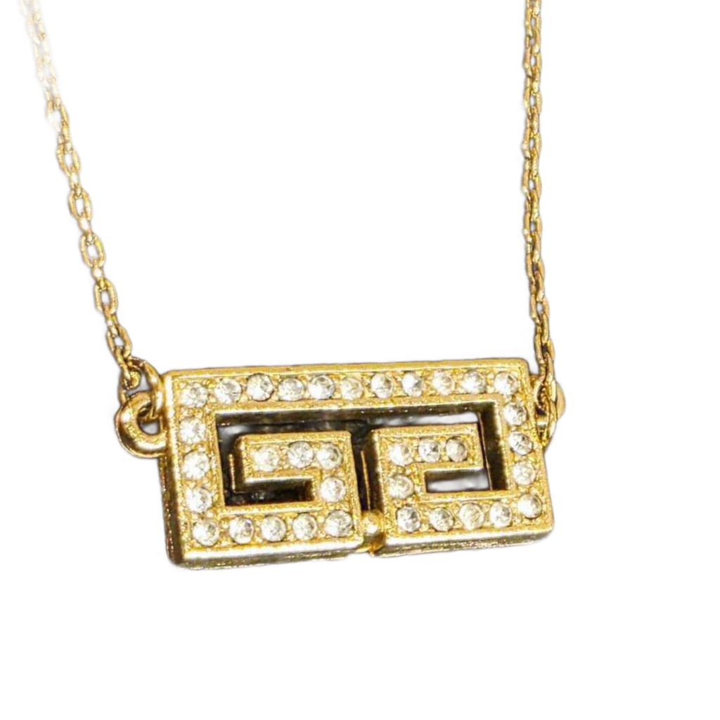 GIVENCHY Collier Givenchy, 1977, logo G, strass, or, excellent état, rare.