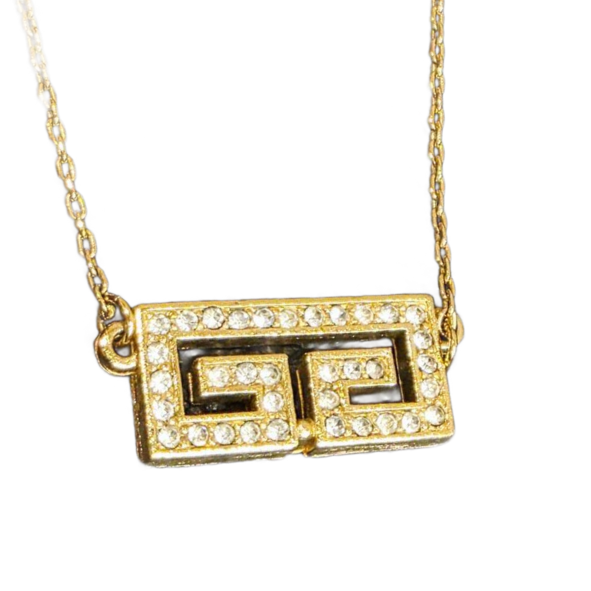 GIVENCHY Collier Givenchy, 1977, logo G, strass, or, excellent état, rare.