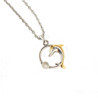 COURRÈGES Collier pendentif motif dauphin argent et or