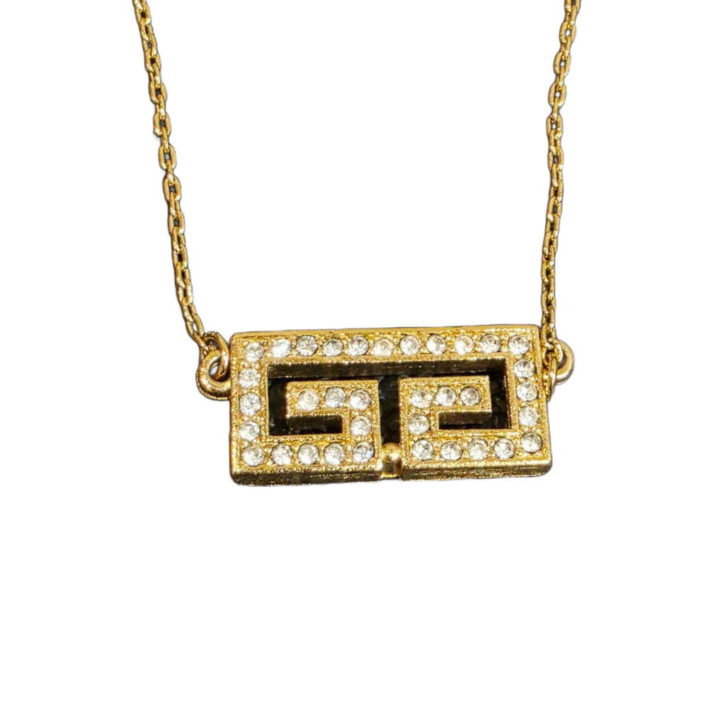 GIVENCHY Collier Givenchy, 1977, logo G, strass, or, excellent état, rare.