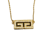 GIVENCHY Collier Givenchy, 1977, logo G, strass, or, excellent état, rare.